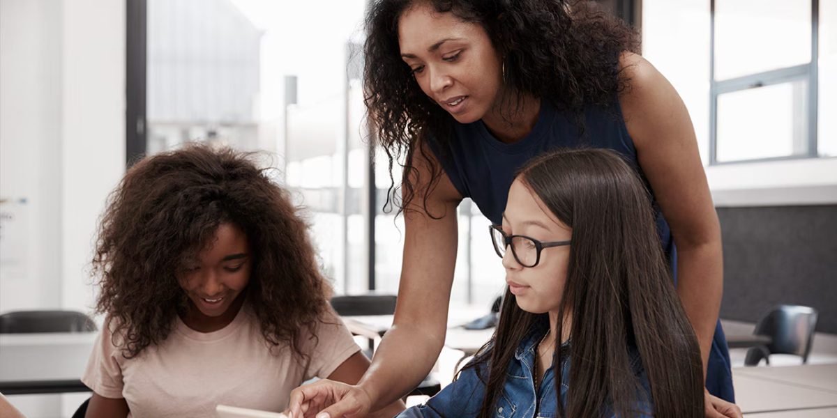 adult and two children on a computer