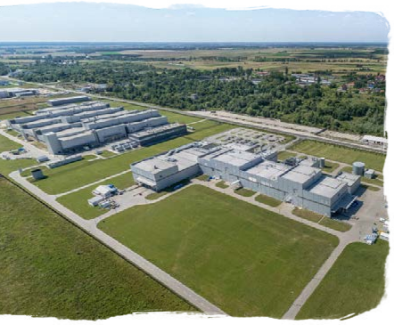 aerial view of many production buildings and driving lanes over a large field