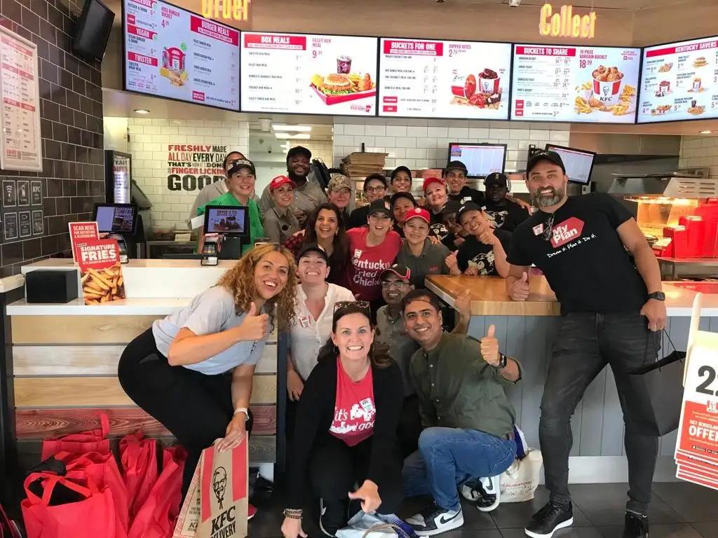 A team of people posed in a restaurant.