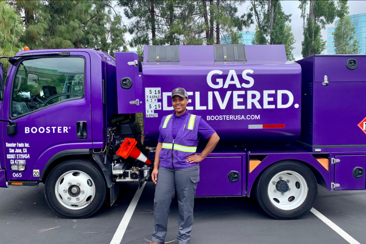 Booster Fuels driver standing in front of truck