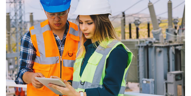 two construction workers using a tablet 