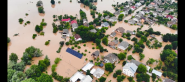 aerial view of a flooded neighborhood, many buildings fully or partially submerged.