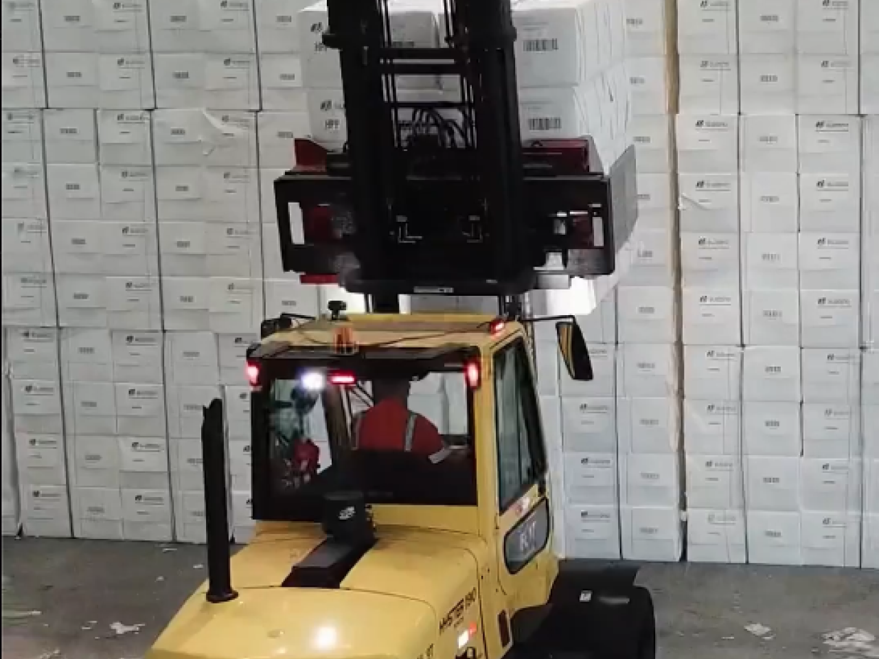 A forklift raising boxes