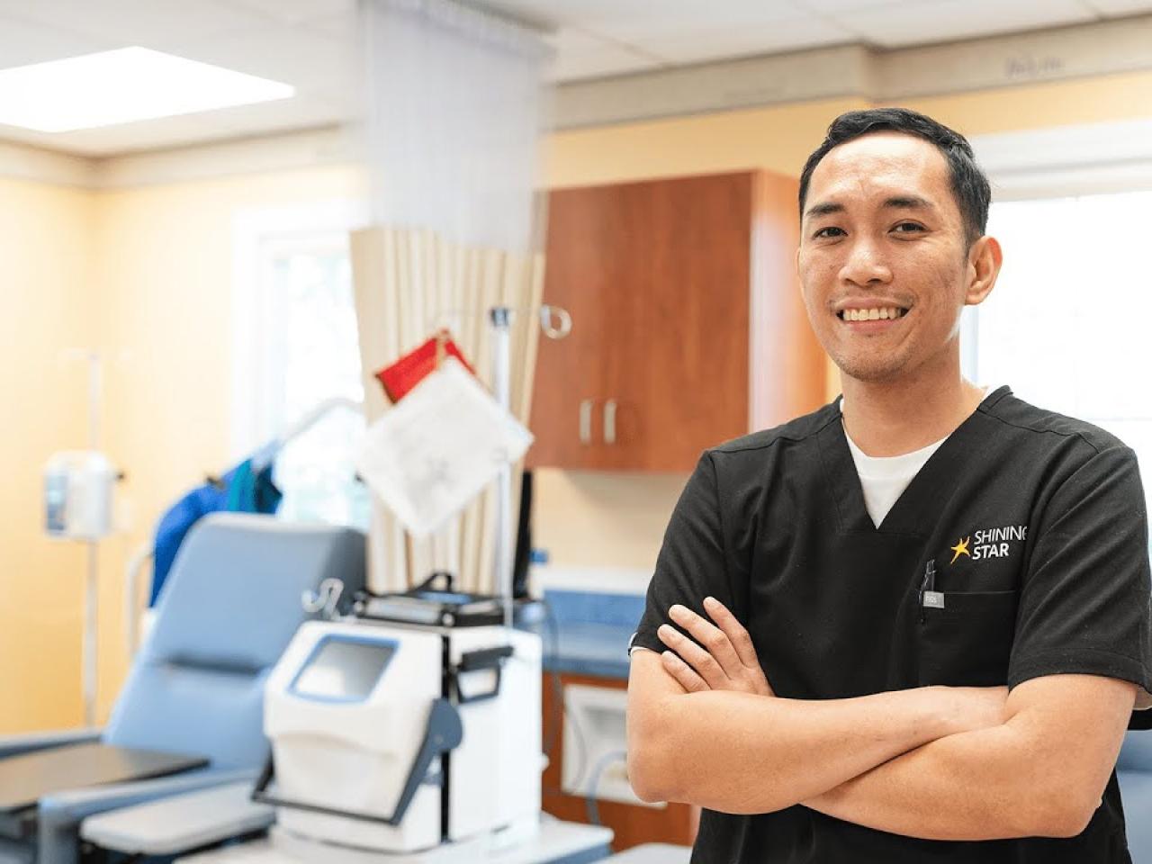 A person in scrubs in a health care setting