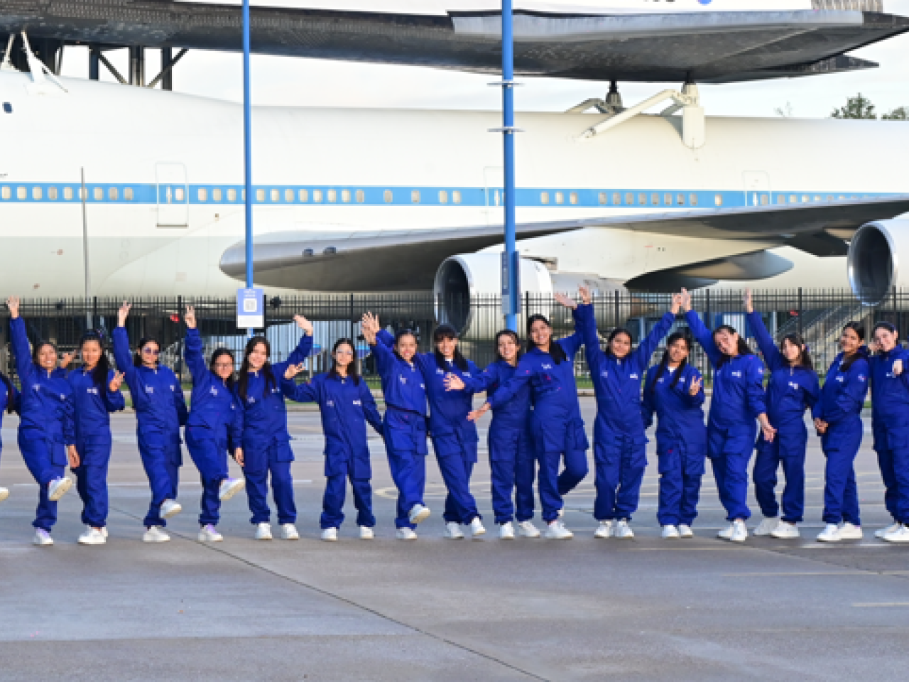 She Is an Astronaut participants in a line in front of a Nasa airplane