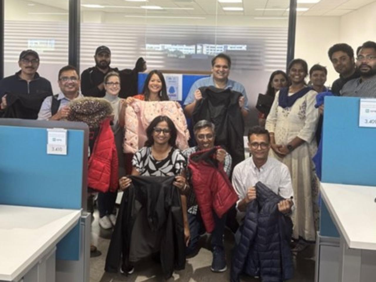 Group of people posing with winter coats