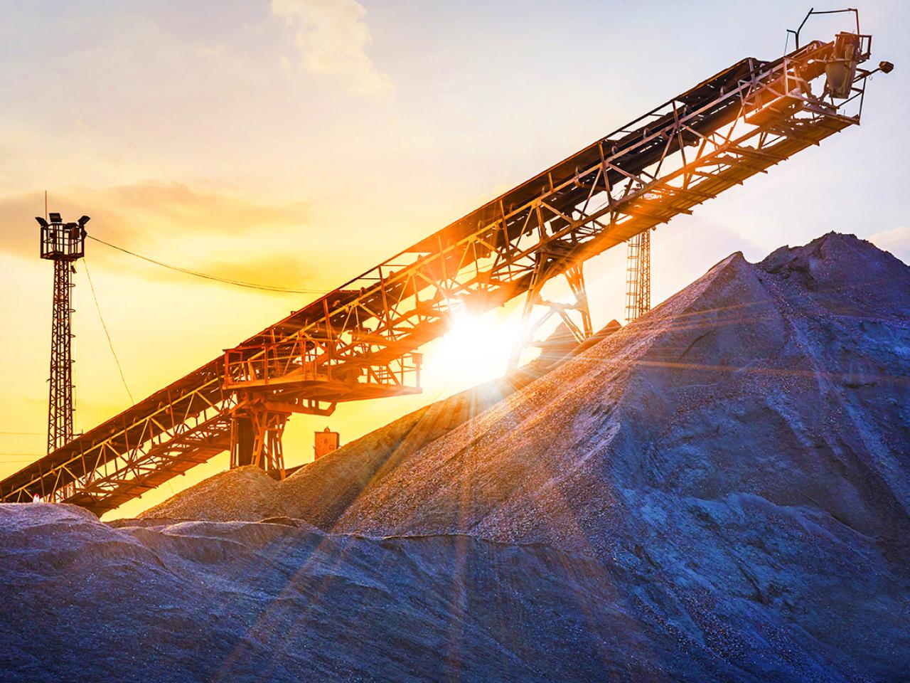 Mining equipment with a sunrise behind it