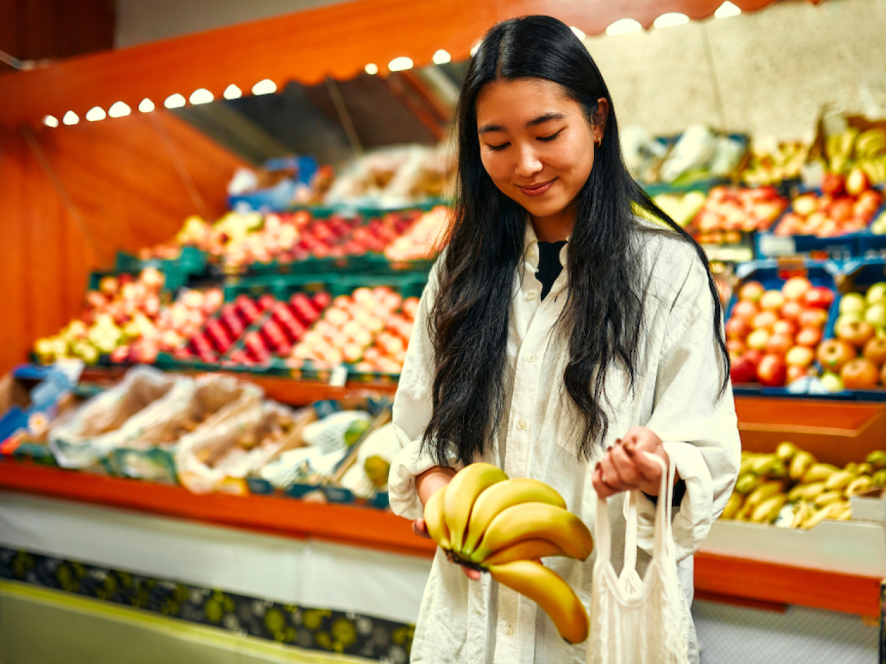 Asian woman shopping in the grocery store.