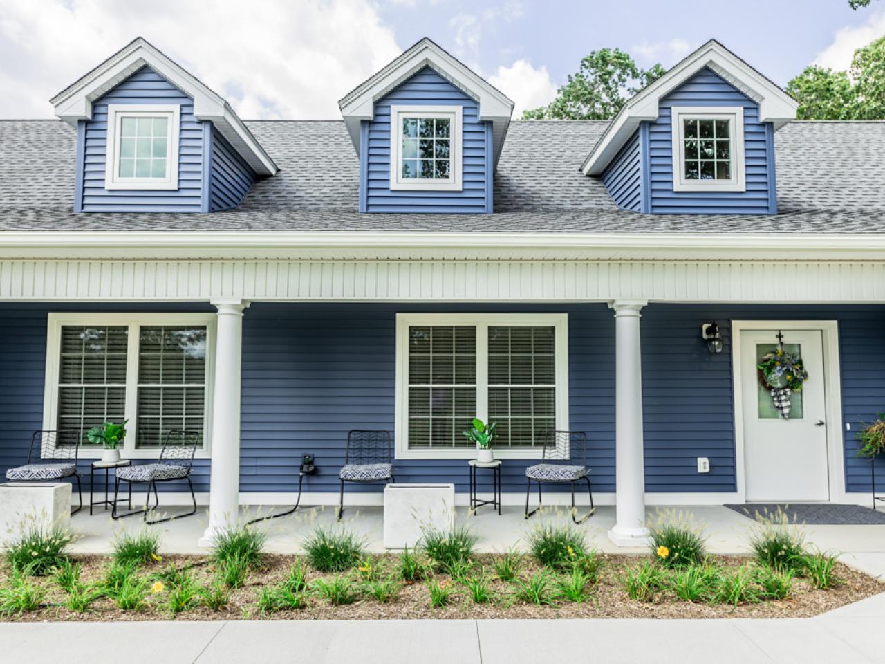 The exterior of a blue house is shown.