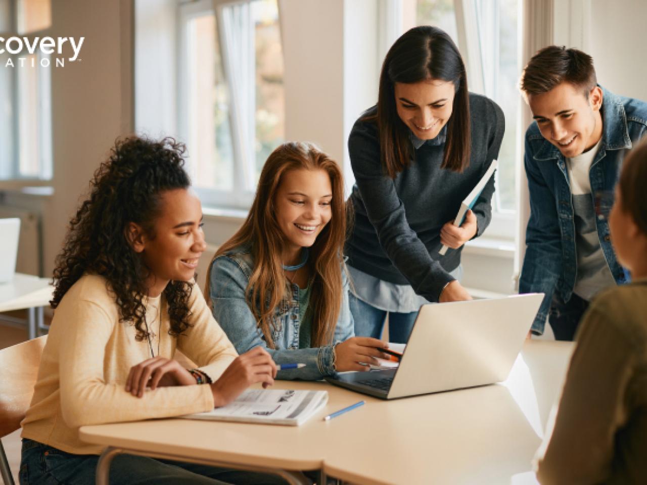 students looking at a laptop together