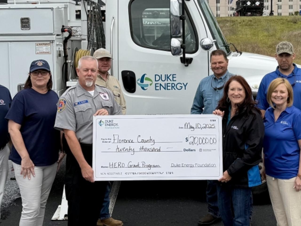 First responders holding check from Duke Energy
