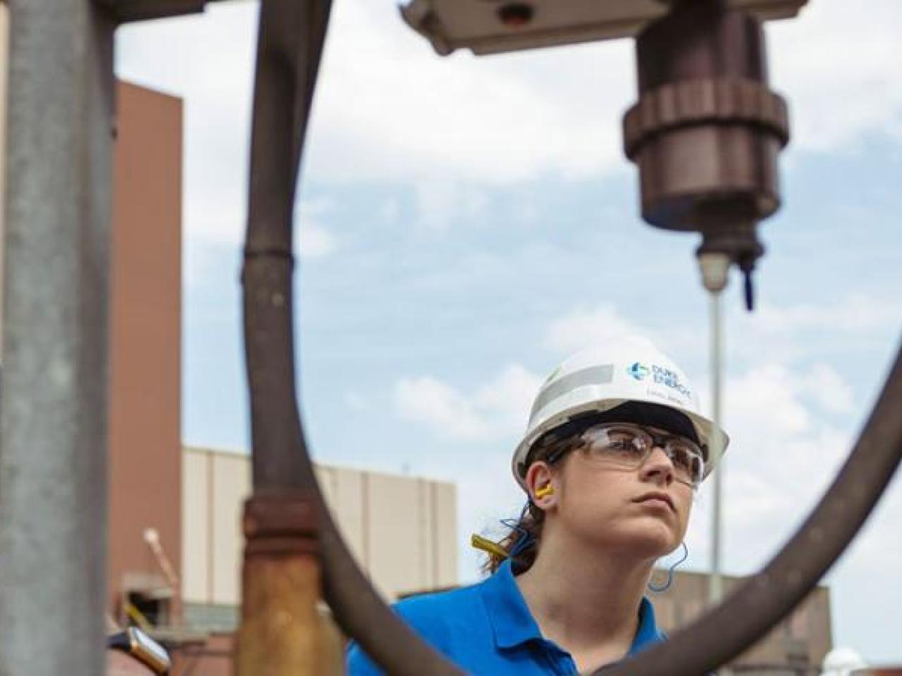 Emily Jones and two others inspecting equipment.