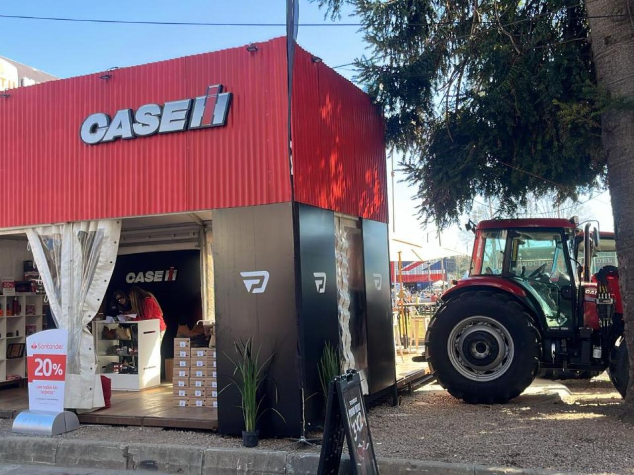 A Case IH sign above a small store with products on shelves. Tractor to the right.