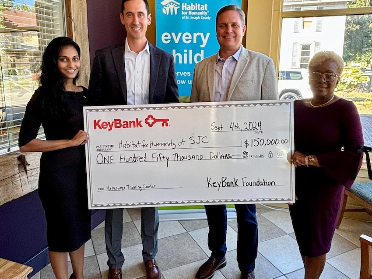 Representatives from KeyBank and Habitat for Humanity shown with a $150,000 grant check.