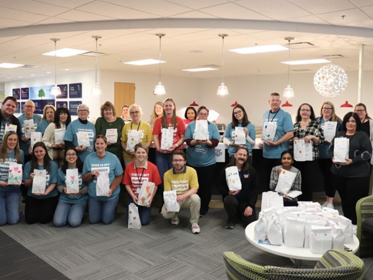 Group of people standing with snack bags