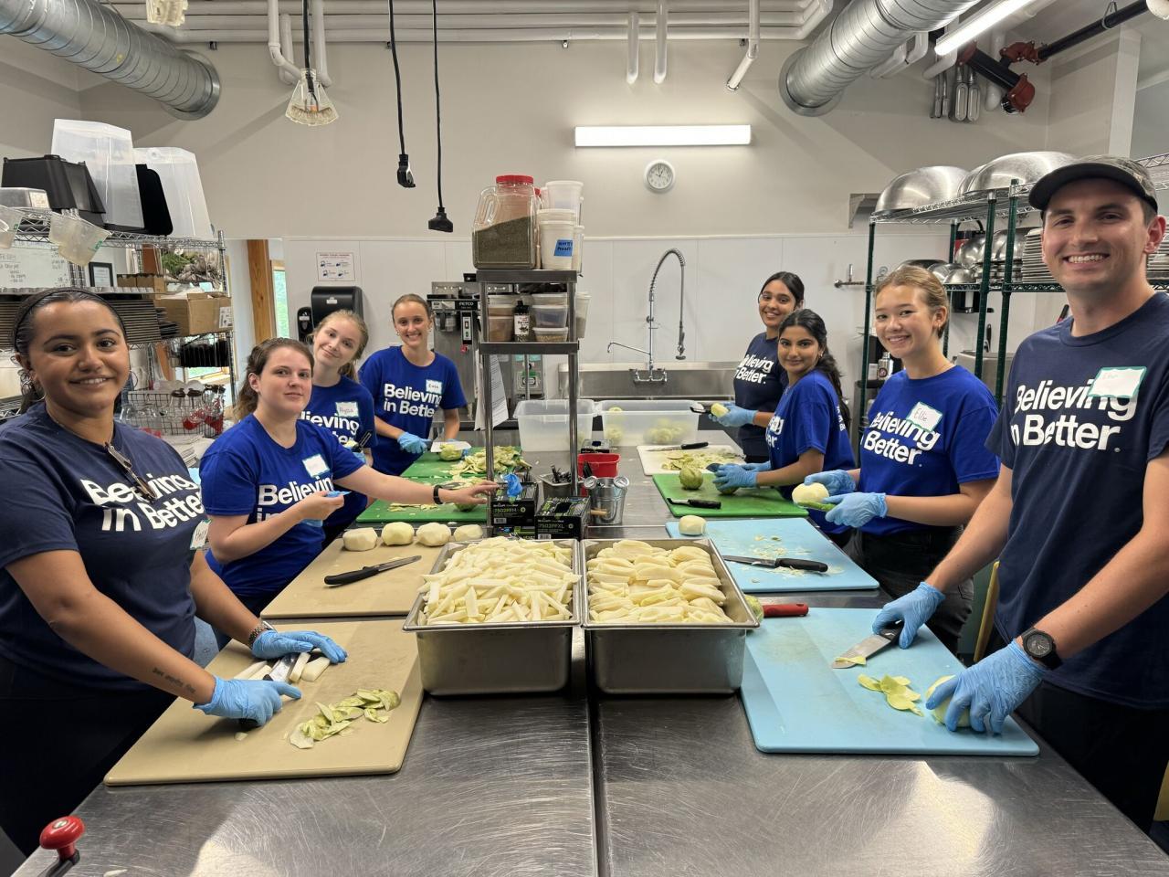 Volunteers cut food in the kitchen