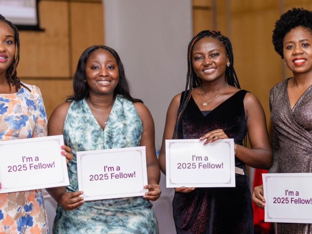 Four people holding signs that read I'm a 2025 Fellow!