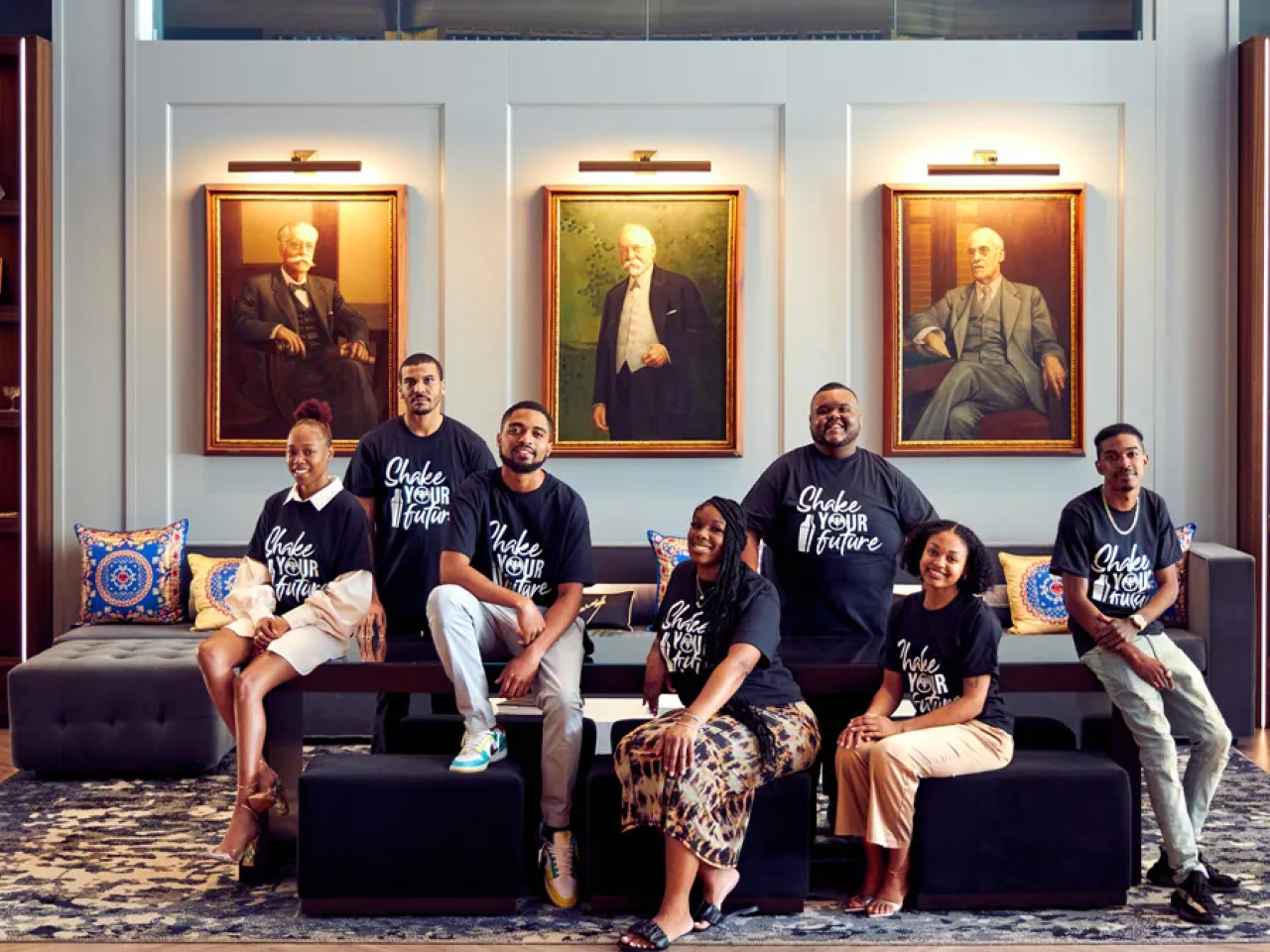 Group photo of 7 people wearing "Shake Your Future" shirts