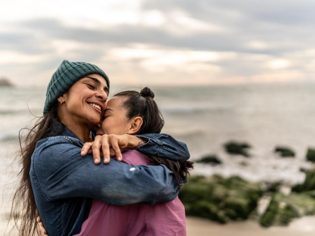 Two people hugging on the beach