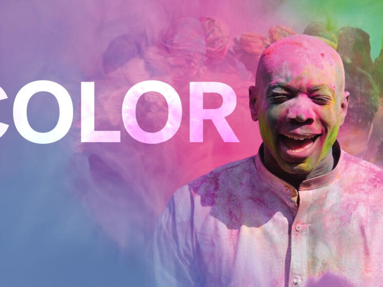 COLOR: A person in a white shirt with colored powder covering them