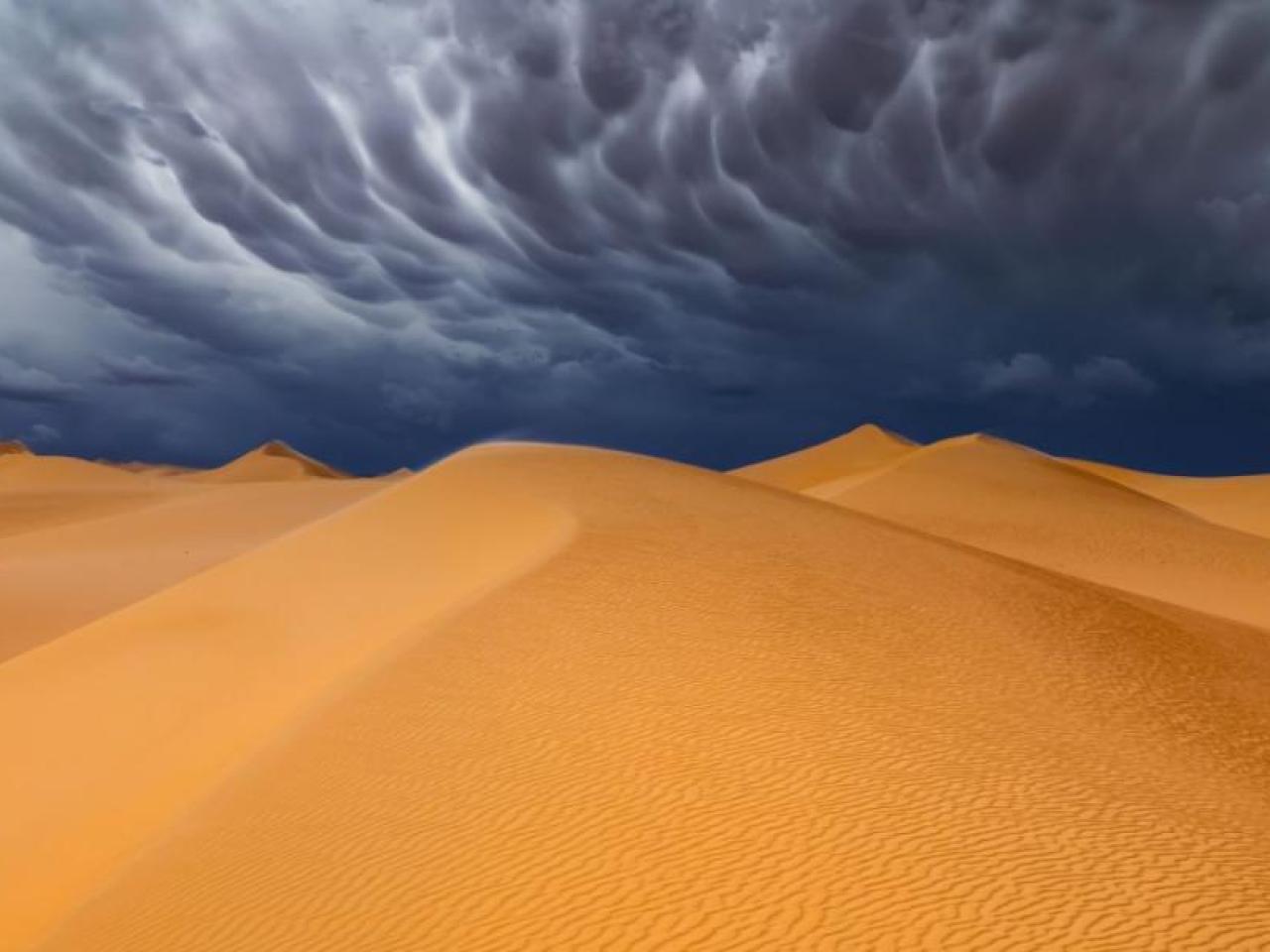 Sand dunes with stormy sky