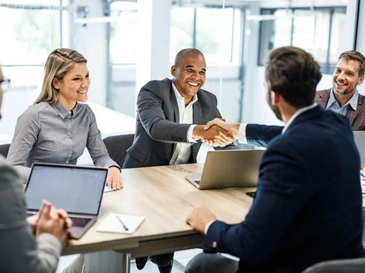 People shaking hands in a meeting