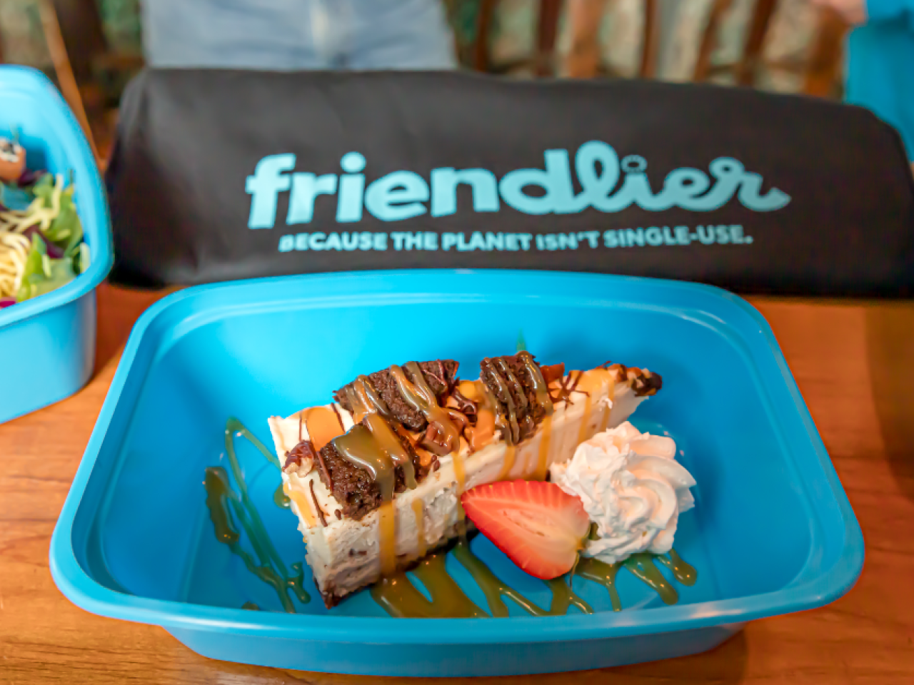 three friendlier containers with food in them, a 'friendlier' bag behind them