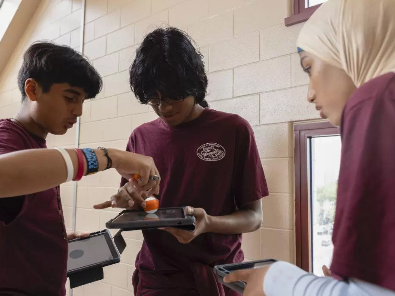 Students working together on tablets