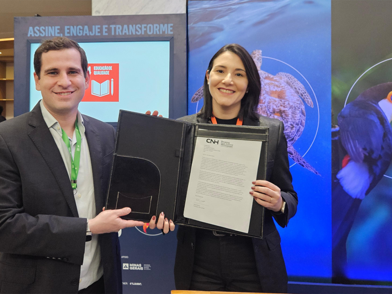 Two people holding a folder