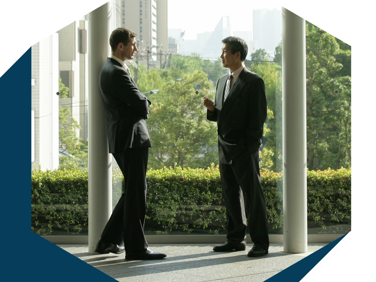 two people in suits talking together