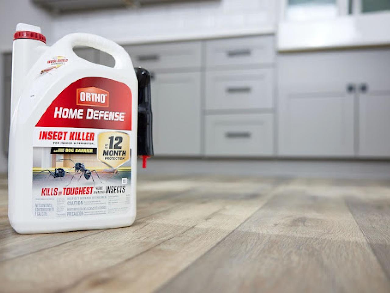 example of new packaging showing container of Home Defense on the floor of a kitchen