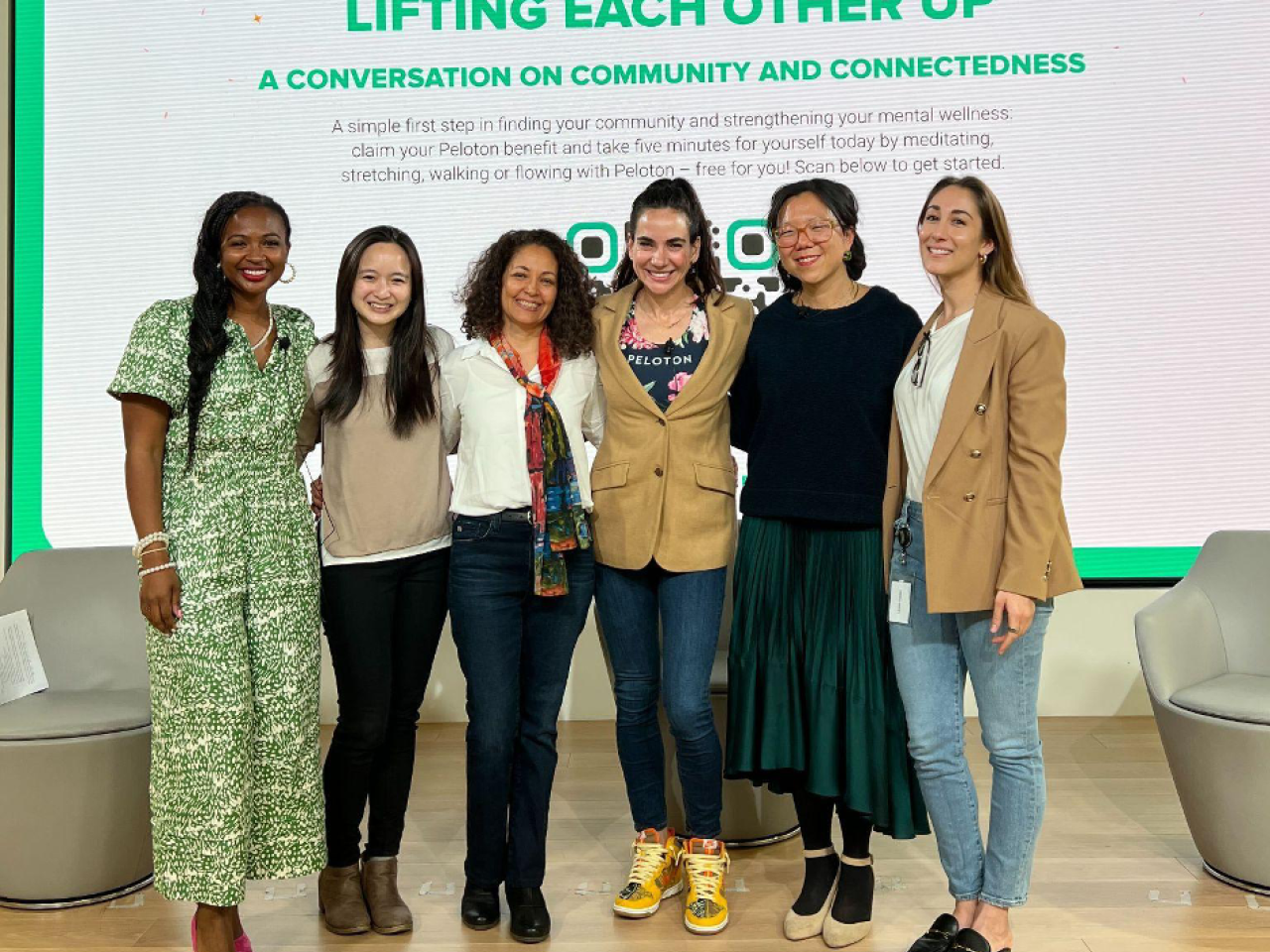 six people standing on a stage