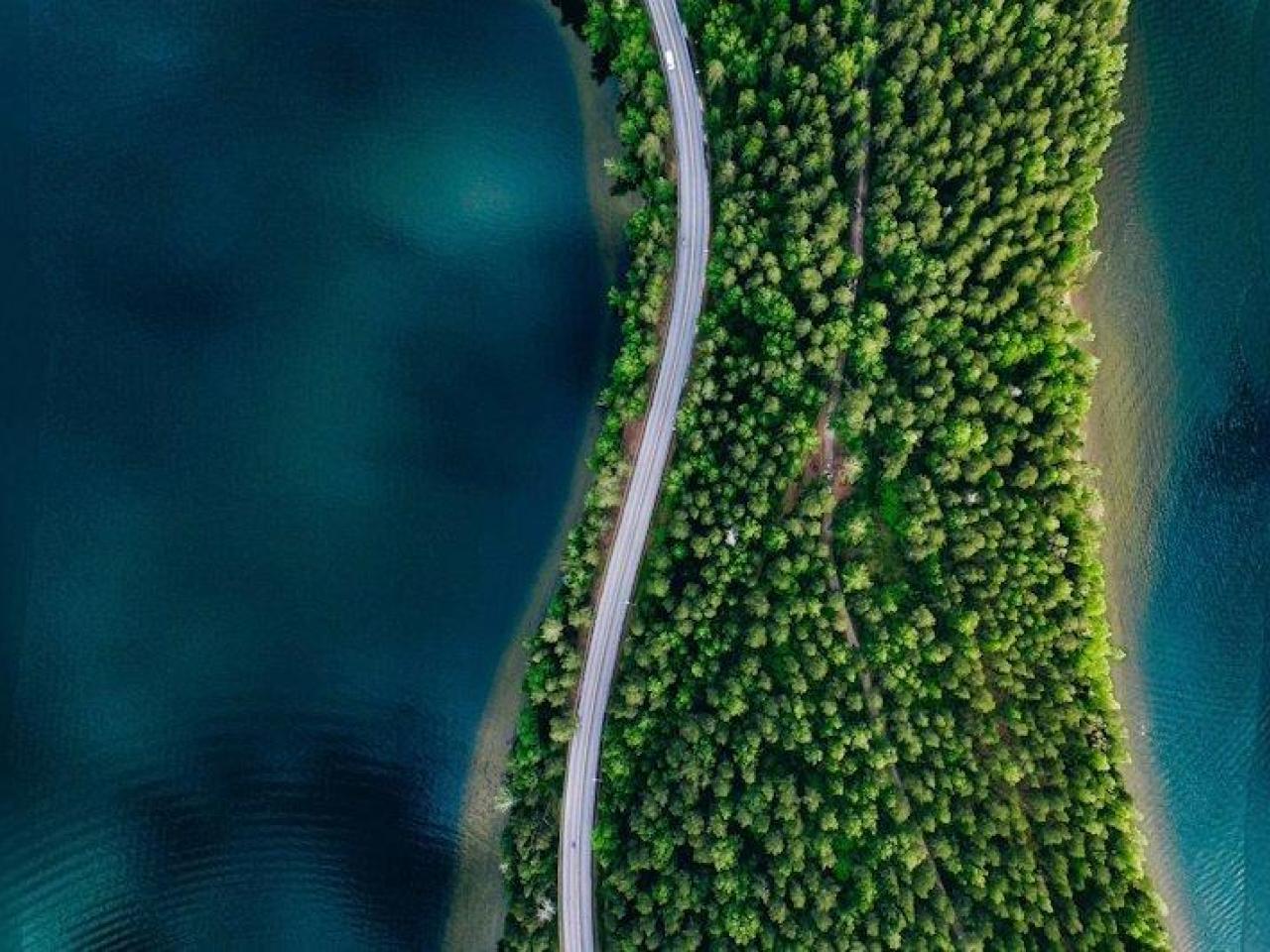 road on land in between water