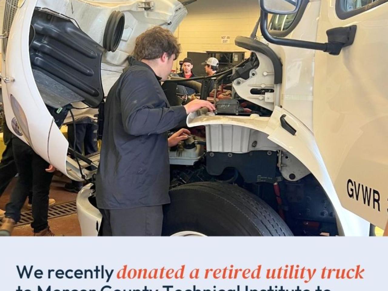 person examining truck engine