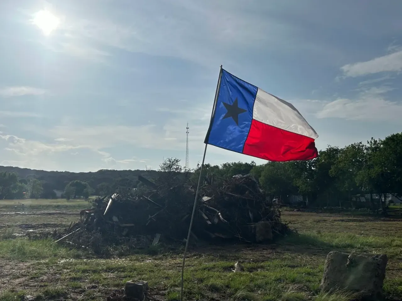 A flag waves in Hunt, Texas, on July 15, 2025, after floods inundated much of the Texas Hill County region. Direct Relief is working to support recovery in the region with emergency grant funds. (Shannon Hickerson/Direct Relief)