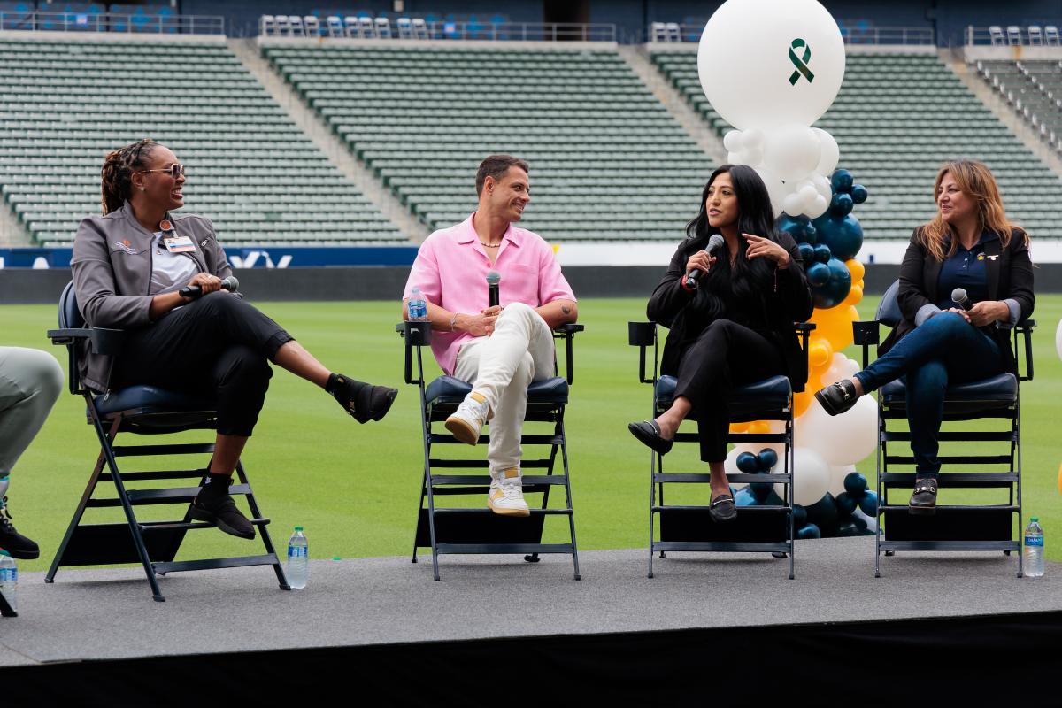 Group of 4 people talking on stage