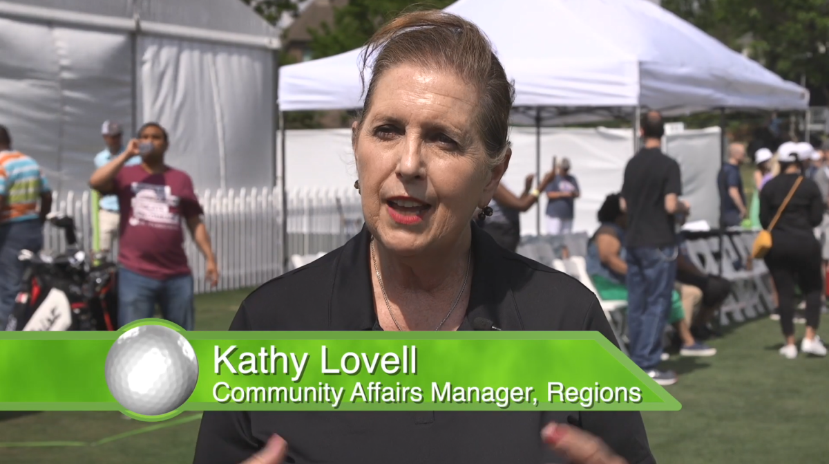 Kathy Lovell, in front of open shade tents.