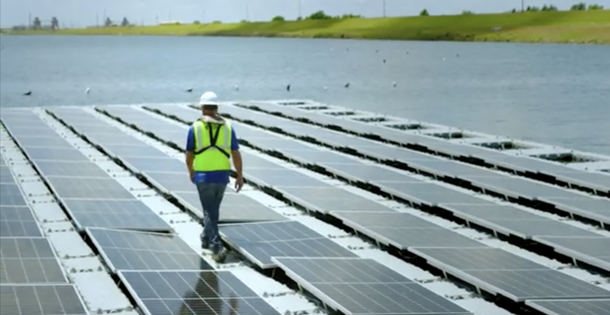 Worker walking on the floating solar array