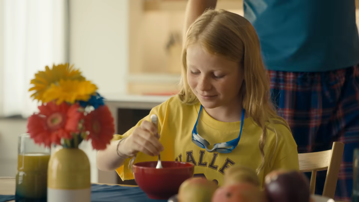 A young child sat at a dining table 