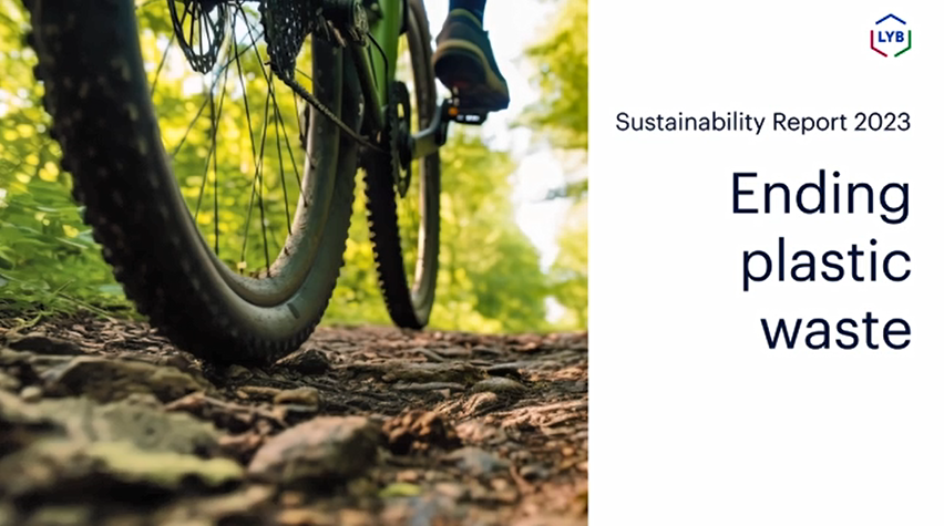 "Ending Plastic Waste" a close up of a person on a bicycle on a leaf-lined path.