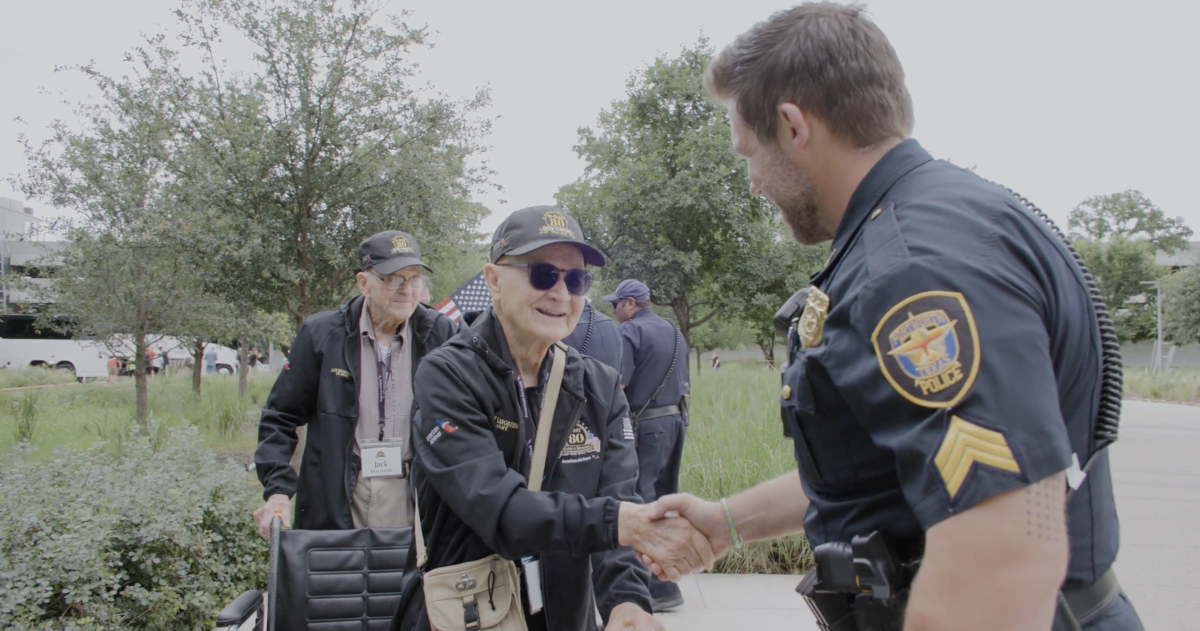 A person shaking hands with a war veteran 