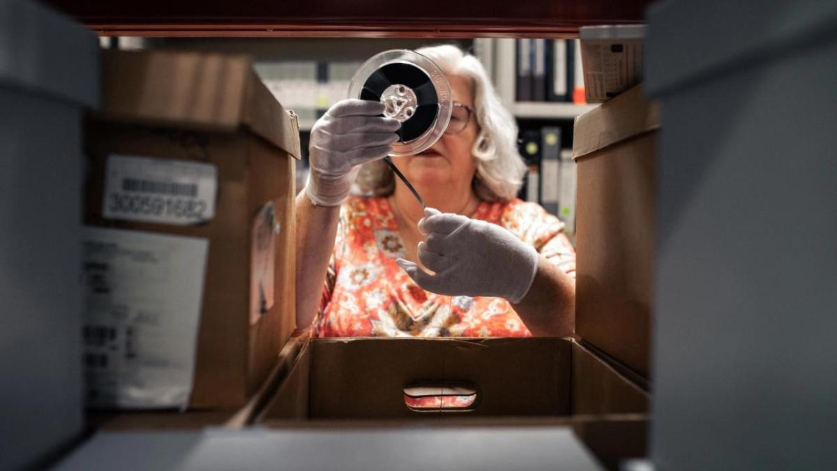 Lori winding up negatives on a roller