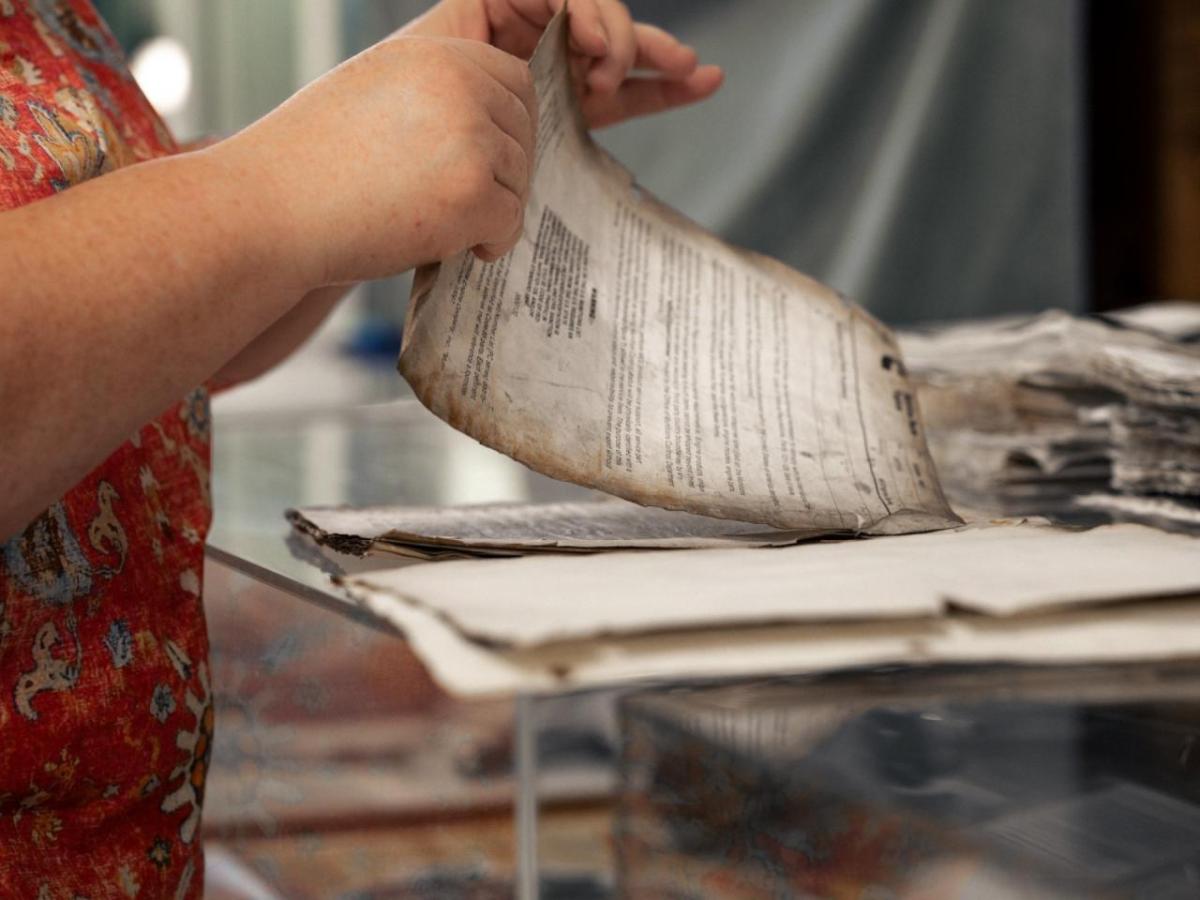 Lori handling very old, discolored papers