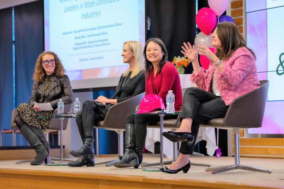 Four people talking on stage