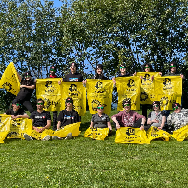 Picture of the Albertsons Companies' Homer, Alaska team outside holding Alaskans for Litter Prevention and Recycling (ALPAR) banners