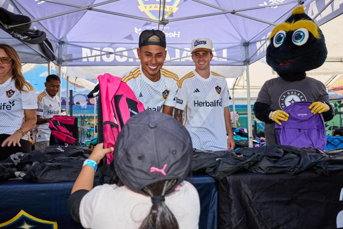 LA Galaxy players handed out backpacks filled with school supplies to students.