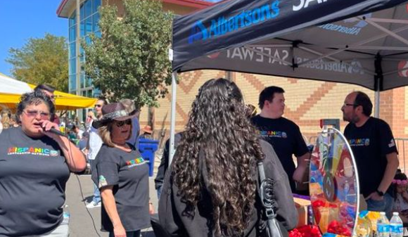 Group of people standing under Albertsons' tent