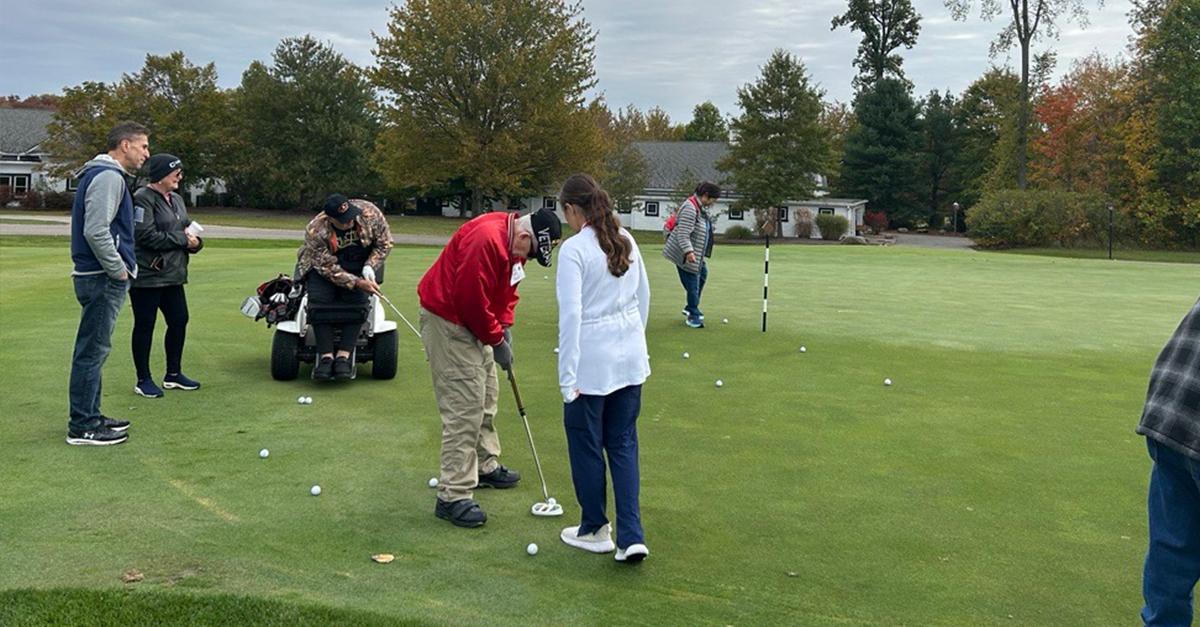 Participants, volunteers, and caregivers at the 2023 Stars, Stripes, and Links Event at Sand Ridge Golf Club in Chardon, Ohio.