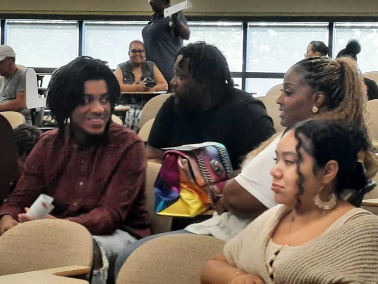 People talking in a classroom.