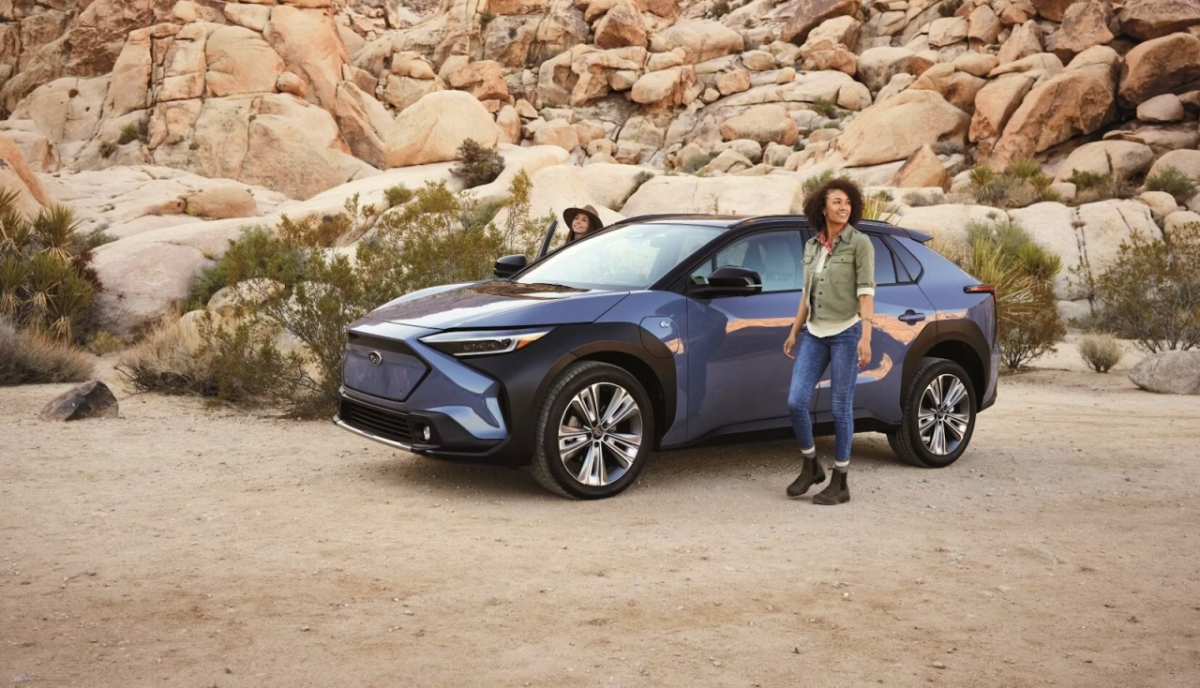 A person standing next to a car